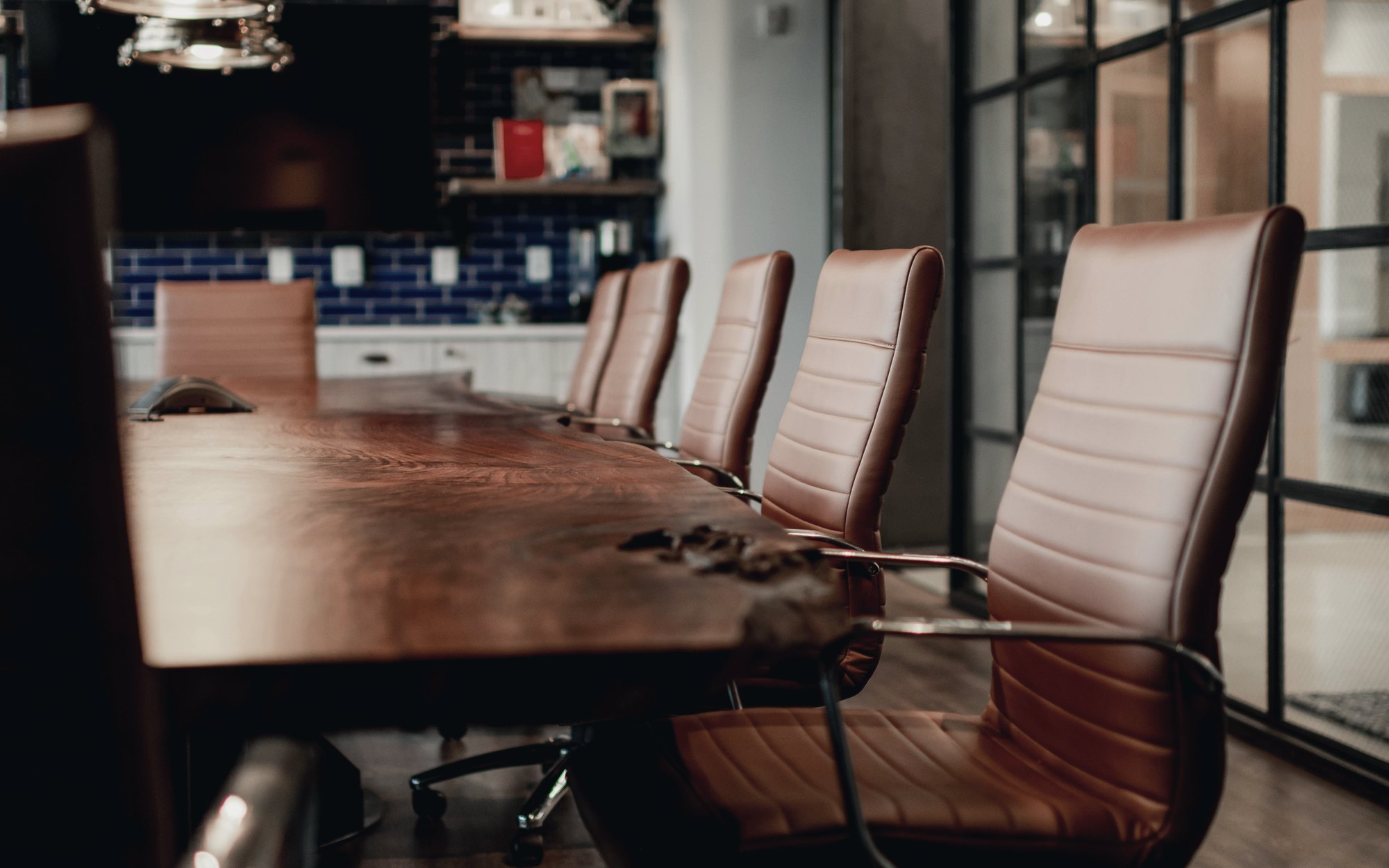 Private boardroom with a live-edge wood table and leather chairs
